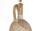 a glass bottle with a handle on a white background
