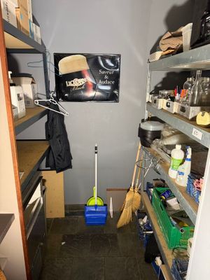 an image of a kitchen with a lot of clutter on the shelves