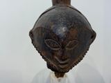 a brown vase with a face on it on a table