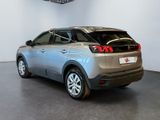 the rear end of a silver car in a showroom