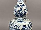 a blue and white vase sitting on top of a table
