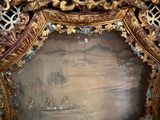 a picture of a gold frame with a painting on it