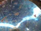 a close up of a metal object with a blue and red design