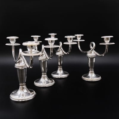 six bougeoirs plaqués argent sur fond noir