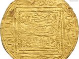a close up of a gold coin with arabic writing on it