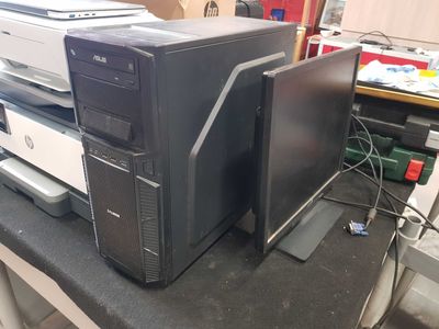 a desktop computer sitting on top of a desk next to a computer monitor
