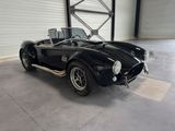 an image of a black sports car parked in a garage
