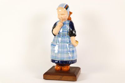 a figurine of a woman wearing a blue and white dress