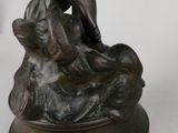 bronze statue of a woman and a dog on a pedestal