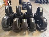 a lot of tires stacked on the floor in a warehouse