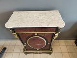 a marble top table with a clock on it