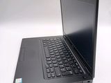 a laptop with a black keyboard on a white surface
