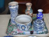a tray that has a bowl, cups, and plates on it