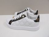 a close up of a pair of white and black sneakers on a table