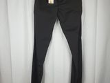 a pair of black pants hanging on a white curtain