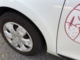 a white car with a sticker on the side of it