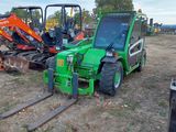 many different types of tractors parked in a field