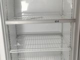 an empty refrigerator with no doors in the kitchen