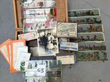 many cards and postcards in a wooden box on the ground