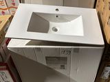 a white sink sitting on top of a wooden pallet