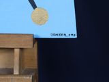 a small easel with a gold medal on it