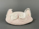 a pink cat hat with a white bow on it