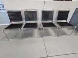 four chairs that are sitting in a row on the floor