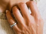 a woman with a ring on her neck and a ring on her hand