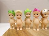 five little plastic dolls that are standing on a table