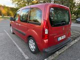 a red van that is parked in a parking lot