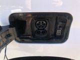 a close up of a car ' s fuel tank with a car plugged in