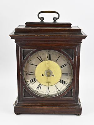 an image of a wooden clock with roman numerals on the face