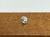 a close up of a diamond sitting on top of a wooden table