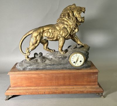 a statue of a lion with a clock on a table