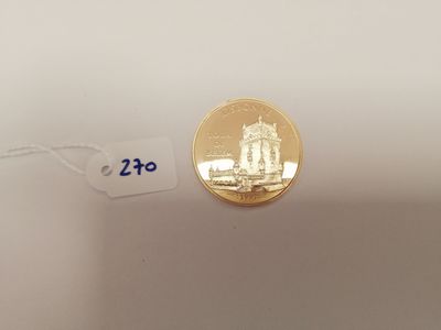 a close up of a gold coin with a price tag on it
