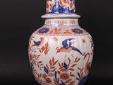 an image of a vase with a bird sitting on top of it