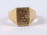 an image of a gold signet ring with a diamond in the center