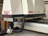 a machine that is cutting a piece of metal