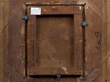 an old wooden picture frame with a label on it