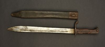 two knives are sitting side by side on a table