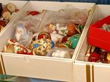 trois bacs remplis de différents types de jouets, posés sur une étagère