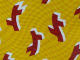 a picture of a pattern of red and white arrows on a yellow background