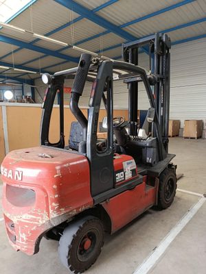 a red forklift truck parked in a warehouse