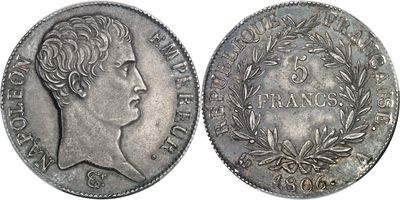 a silver coin with a woman ' s head and laurels on it