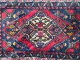 an oriental rug with a red and blue design on a white background