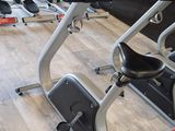 a row of stationary exercise bikes in a gym