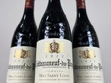 three bottles of red wine sitting on top of a white table
