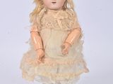 a doll that is wearing a dress and a hat