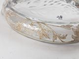 a clear glass bowl with a gold design on it
