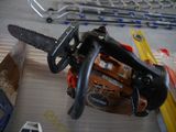 a chainsaw sitting on top of a table next to other tools